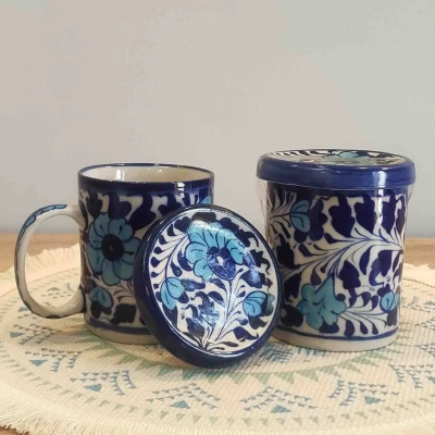 Two ceramic mugs with hand-painted light blue floral vine design in traditional Multani pottery style.