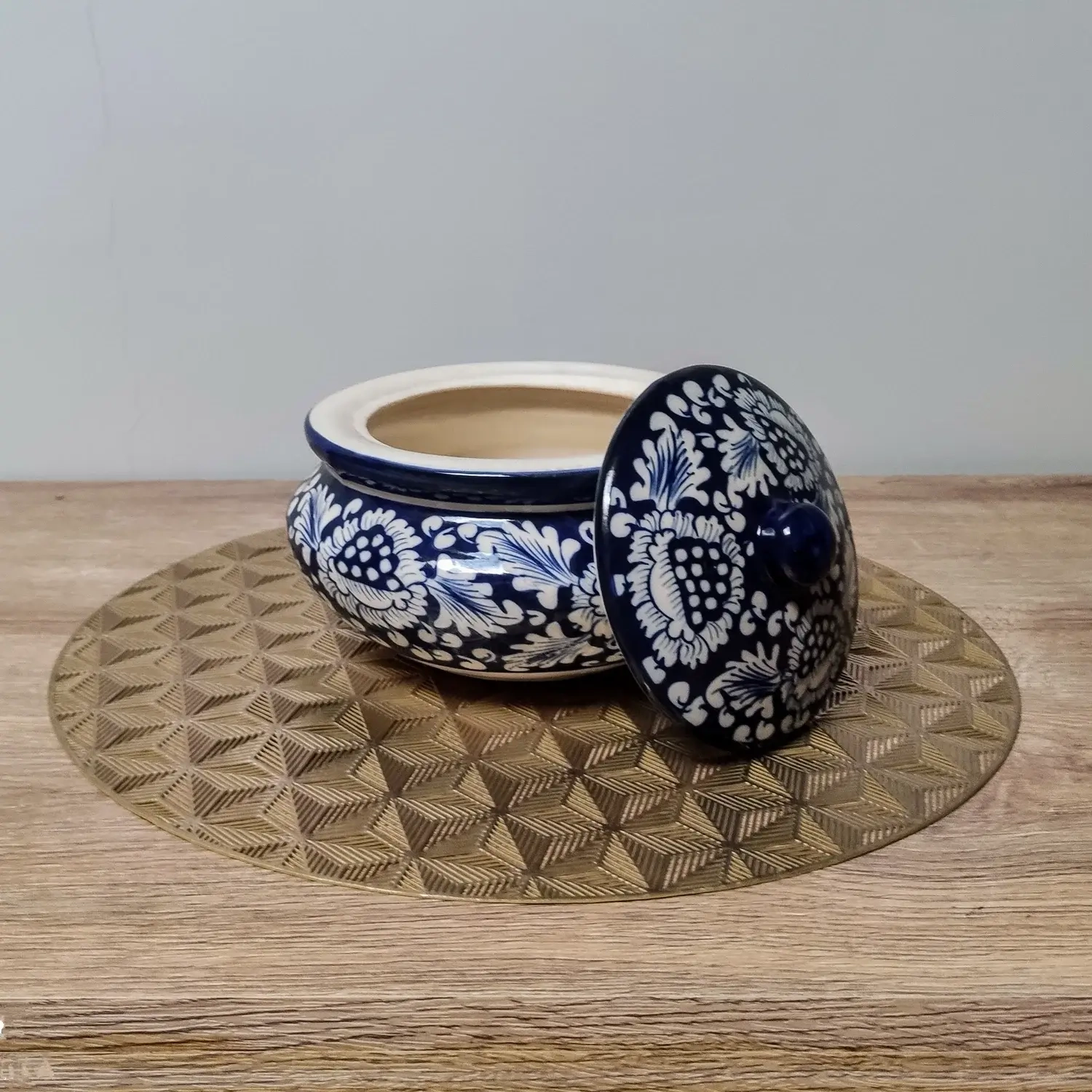 A round ceramic handi-style container.