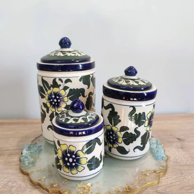 Hand-painted Multani pottery jars featuring the elegant Gul Daudi motif in white, yellow, and green. Perfect for stylish storage and adding a vibrant artisanal touch to your home décor.